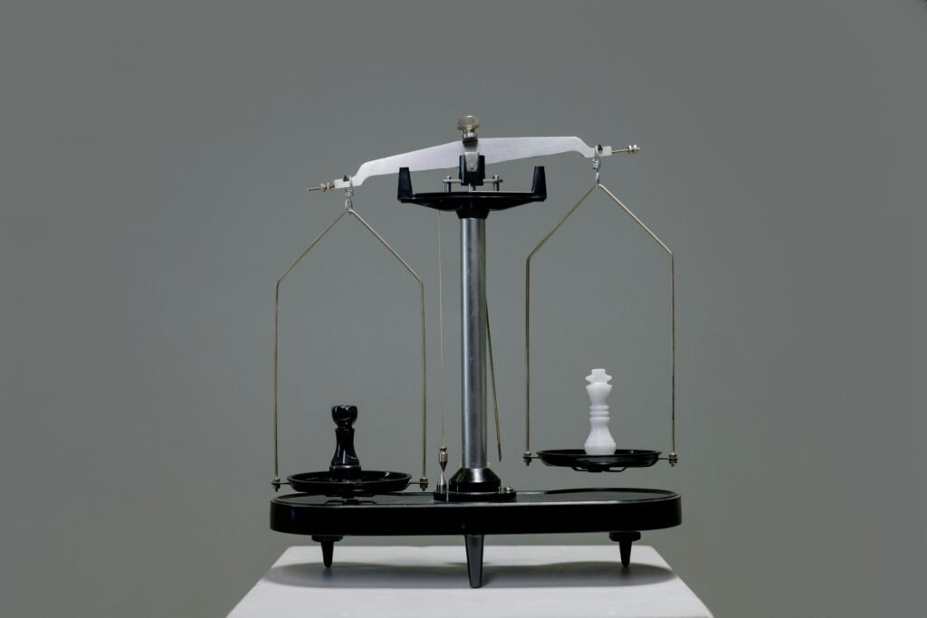 A weight balance with an item on each plate
