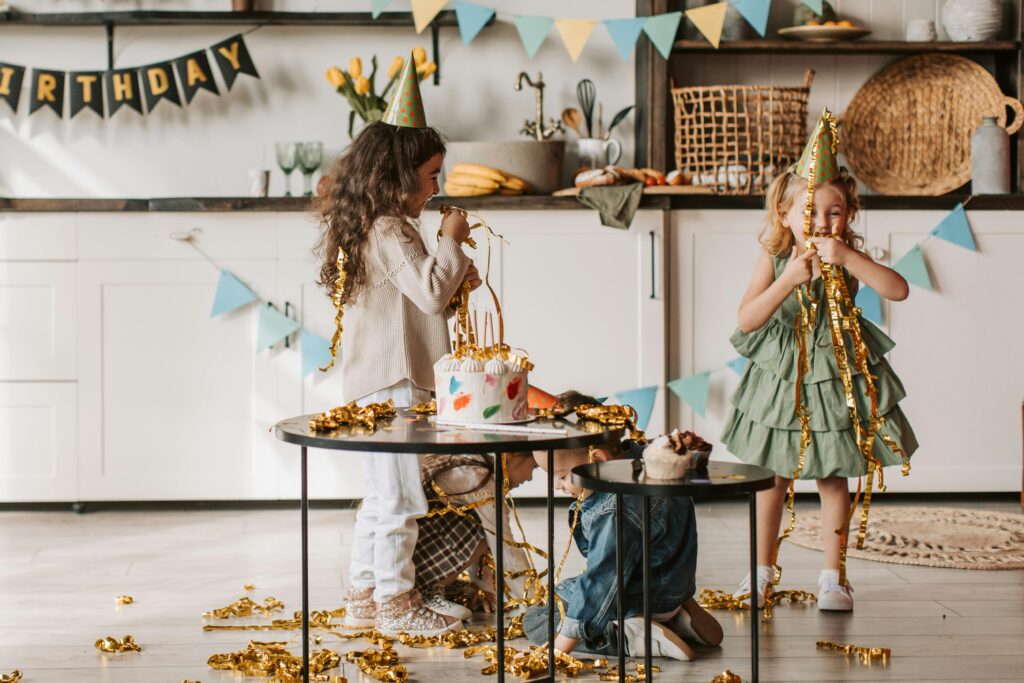 Two children playing with birthday decorations